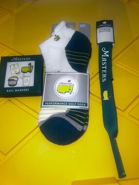 Masters Access bundle
Set of 4 ball markers
Mens golf socks 
Sunglasses holder
